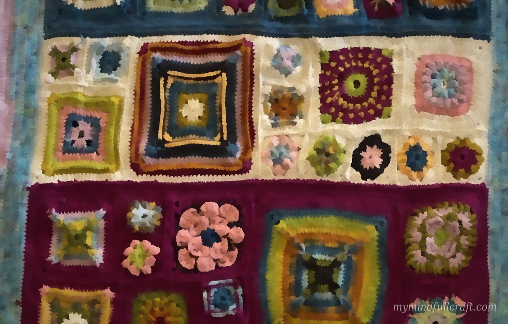 Close-up of crochet granny squares and flower motifs