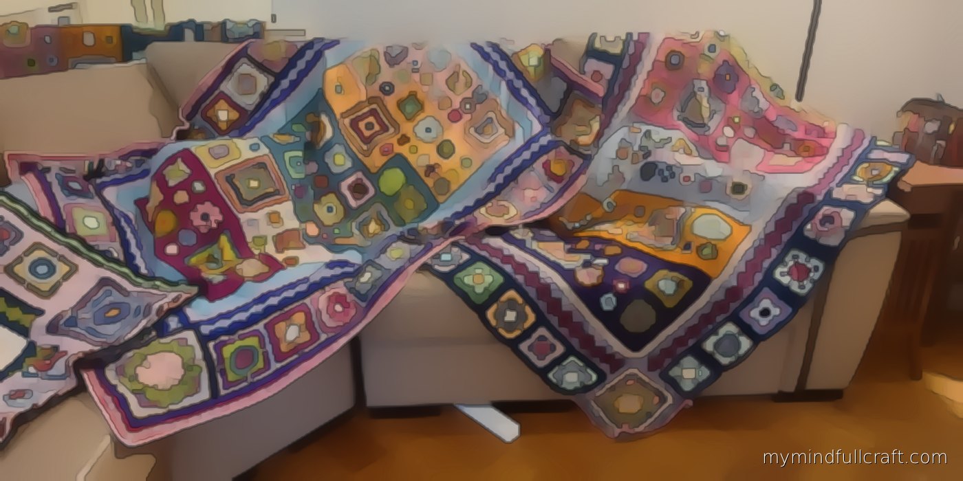 Finished pieces from our studio: three crochet sampler blankets of colourful squares and flowers draped across a sofa